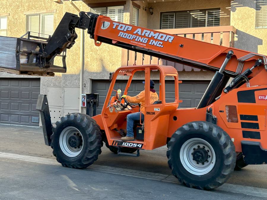 Branded telehandler at a community re-roof