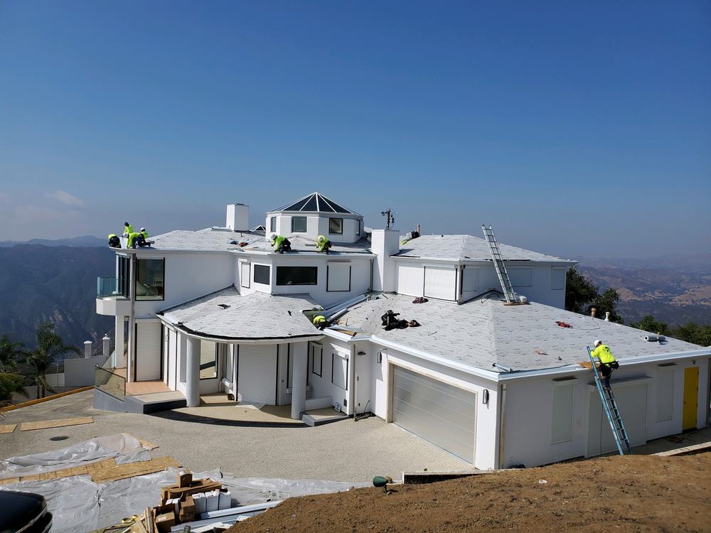 Standing seam metal installation in progress on hilltop estate